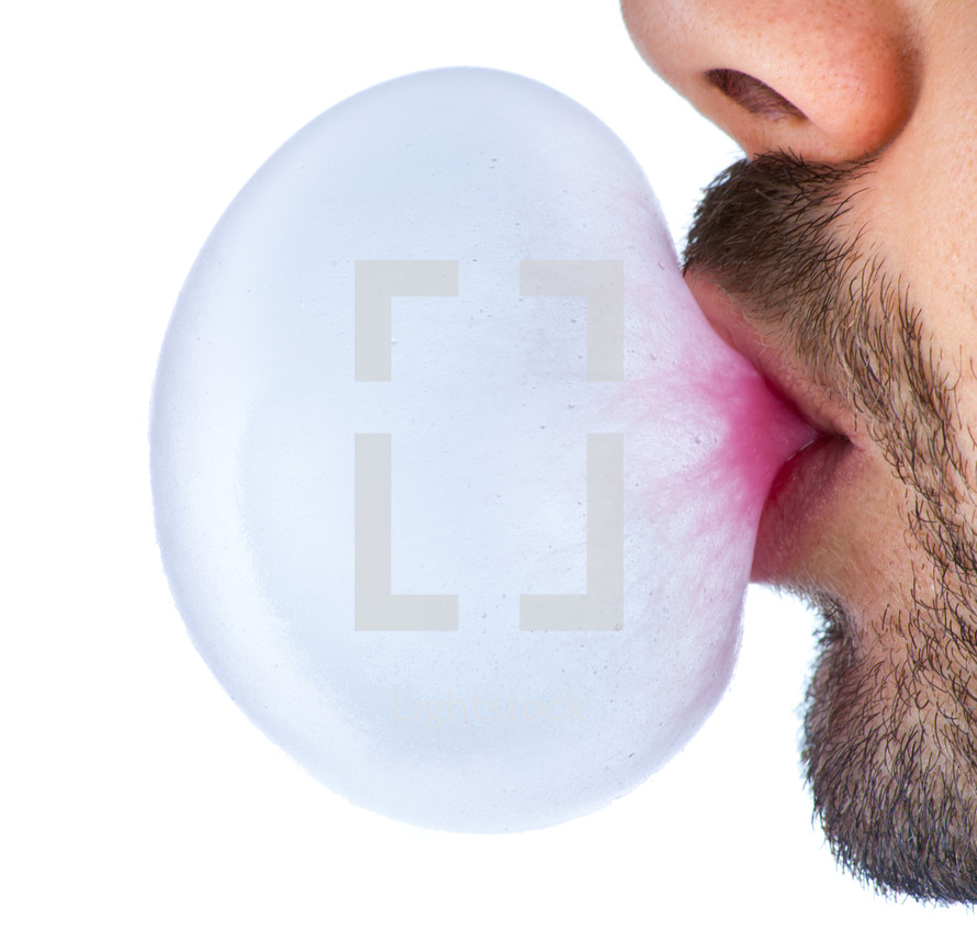 man blowing a bubble 