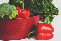 red and green fresh vegetables in a bucket 