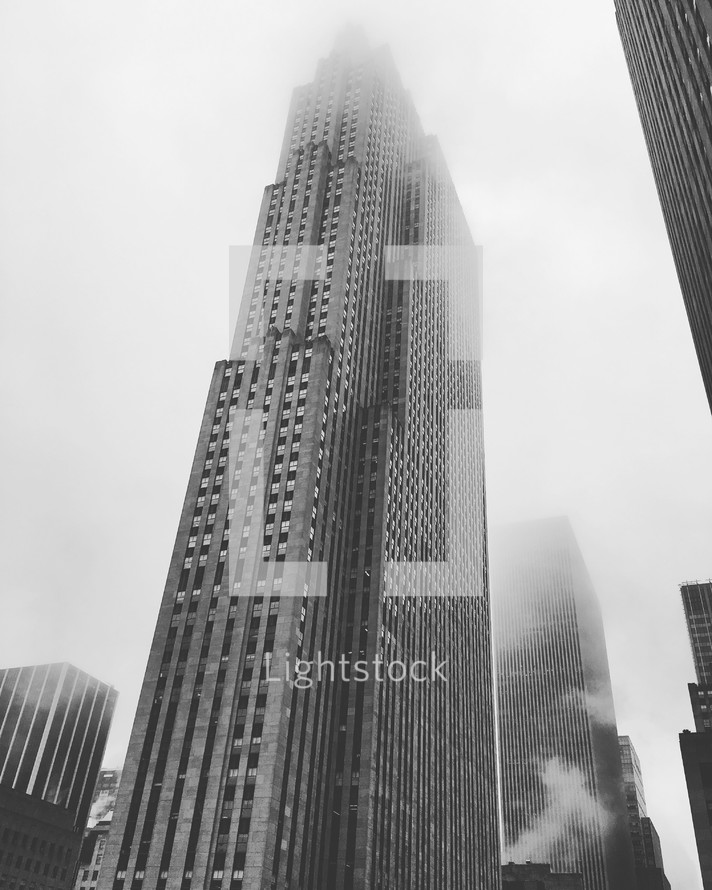 tall city buildings in fog 