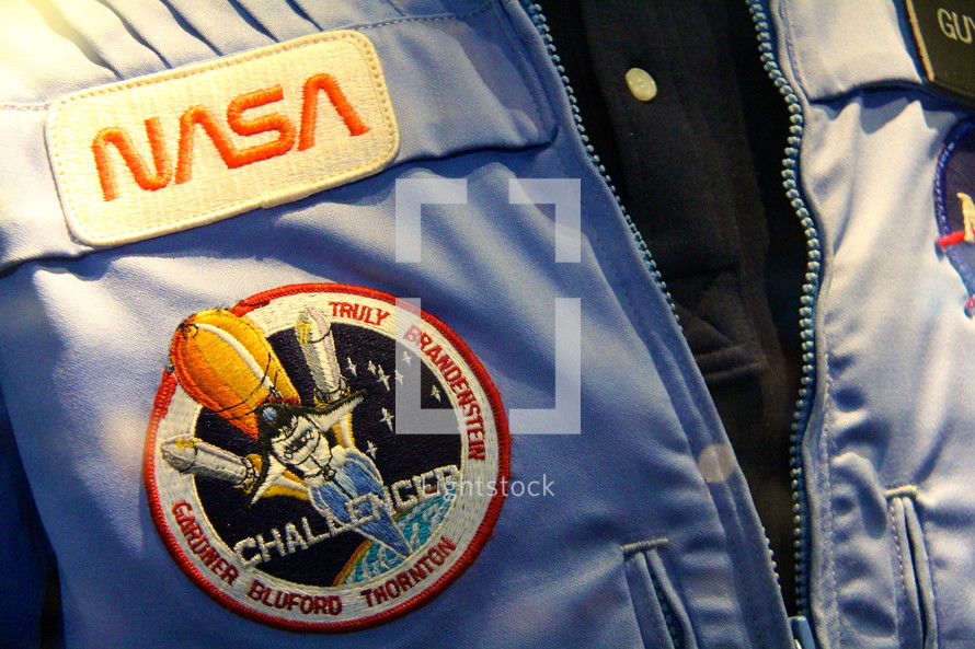 NASA astronaut waring Challenger Space Shuttle insignia