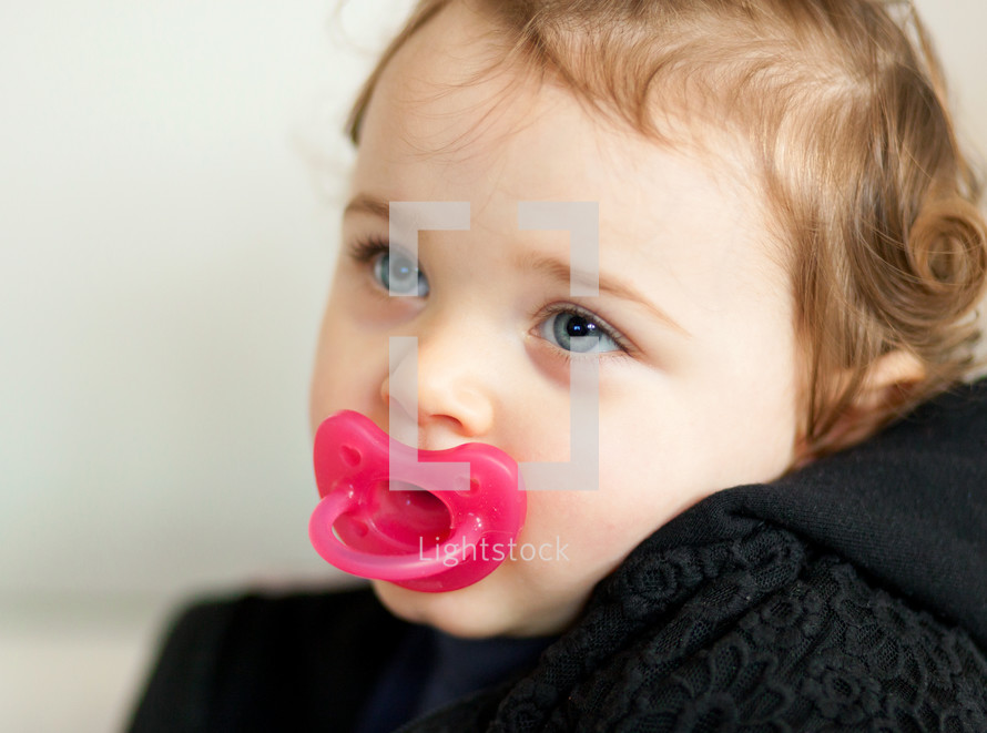 a baby with a pacifier 