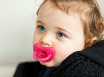 a baby with a pacifier 