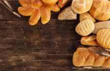 bread and rolls on a wood background 