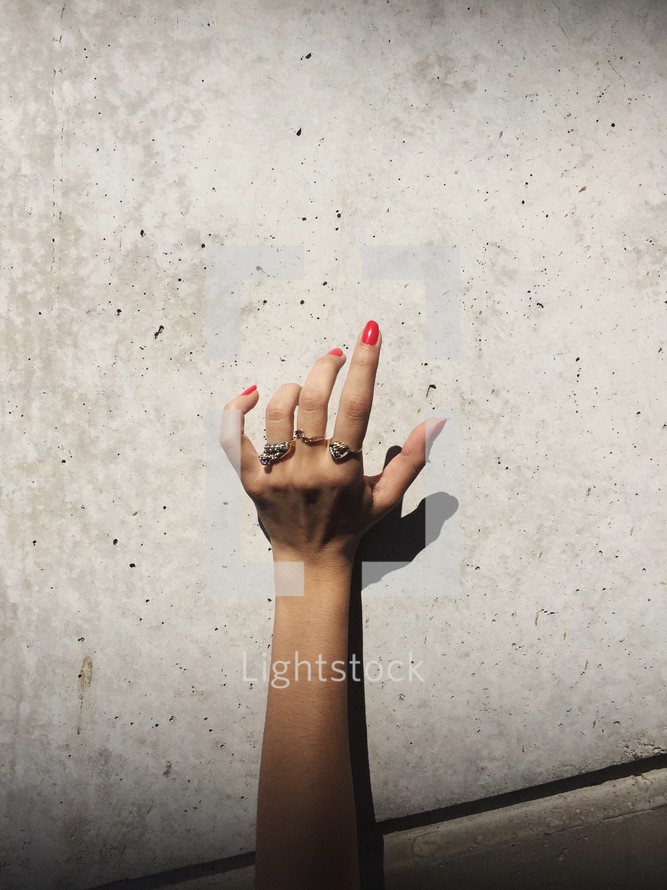 woman's hand wearing rings 