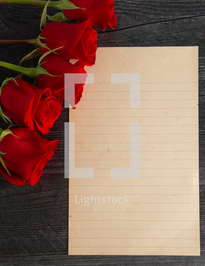 long stem roses and blank paper 