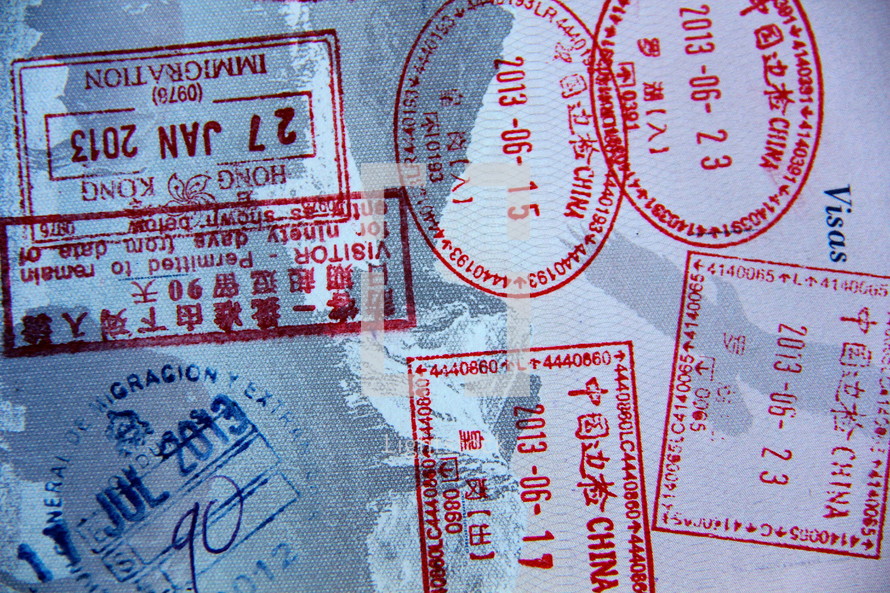 Border crossing stamps in a passport