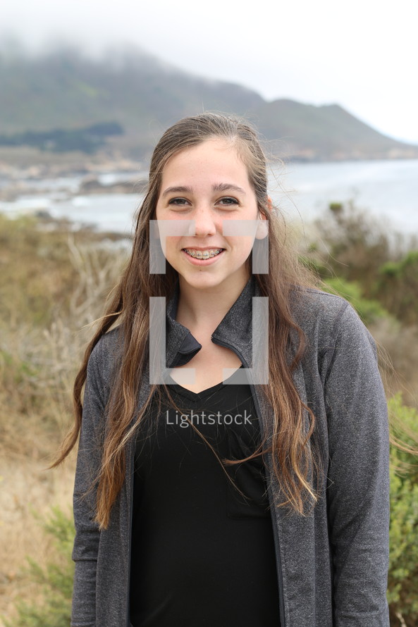 headshot of a teenage girl with braces 
