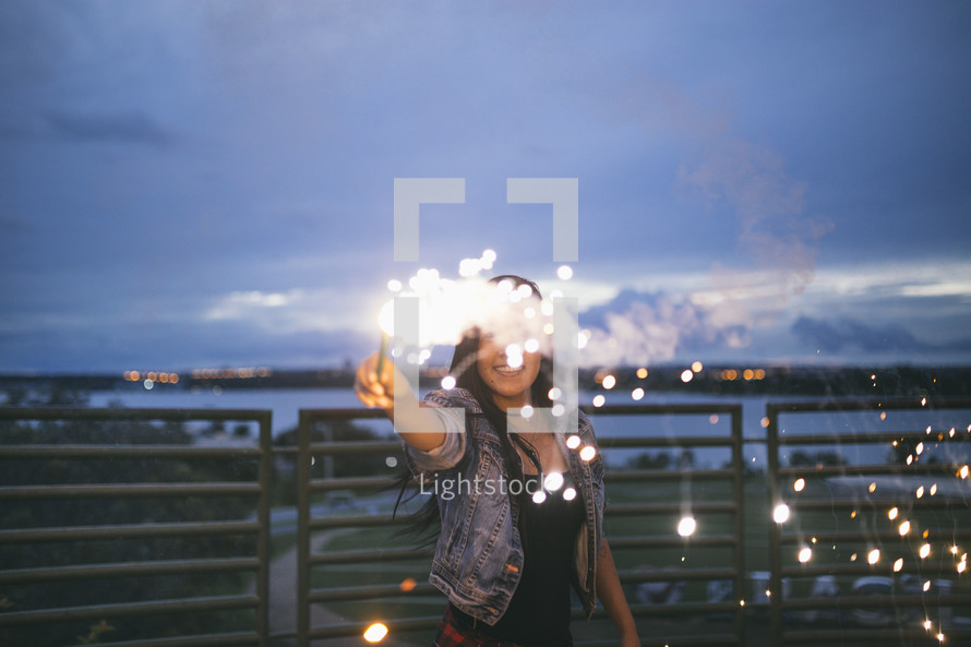 woman holding a sparkler outdoors 