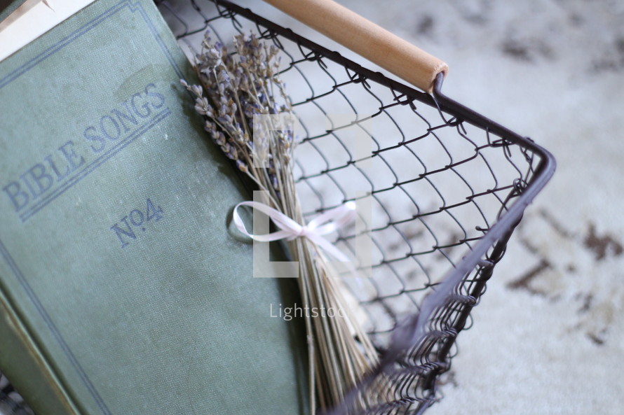Bible songs book and lavender in a wire basket 