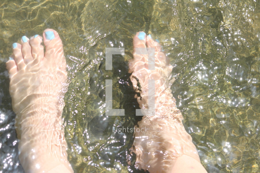 A woman's feet in a river.
