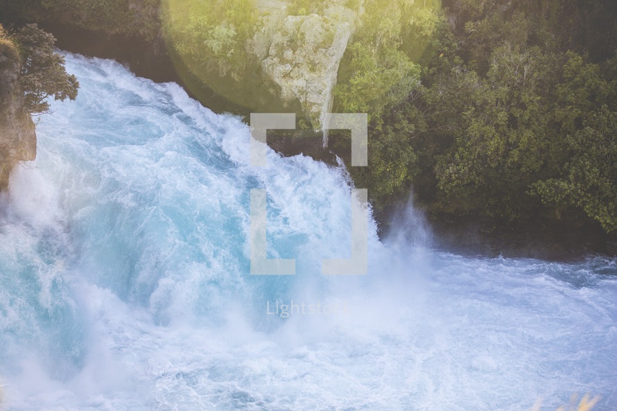 water rushing down a waterfall 