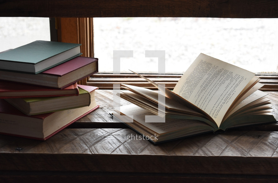 books in a window sill 