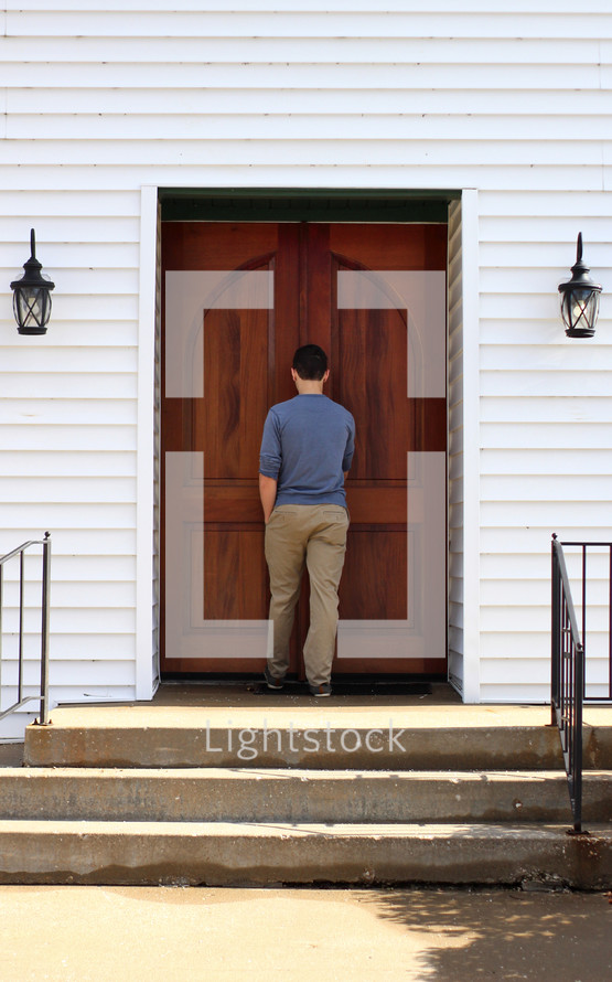 a young man entering a church 