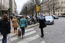 women walking across a crosswalk 