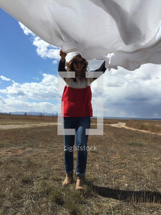 woman holding a white sheet 