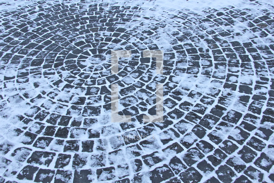 Snow and Ice-covered circular stone path.