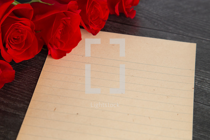 long stem roses and lined paper 