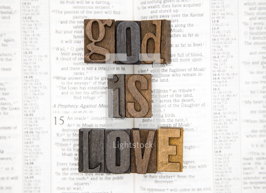 words god is love on the pages of a Bible 