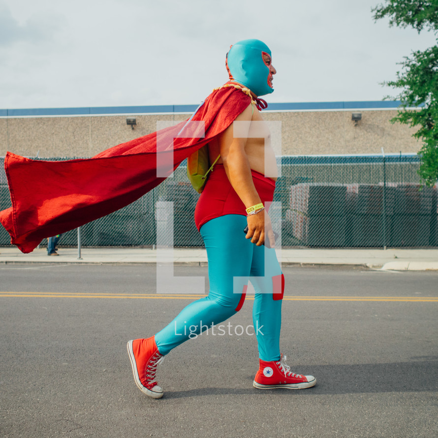 man walking down the street in a super hero costume