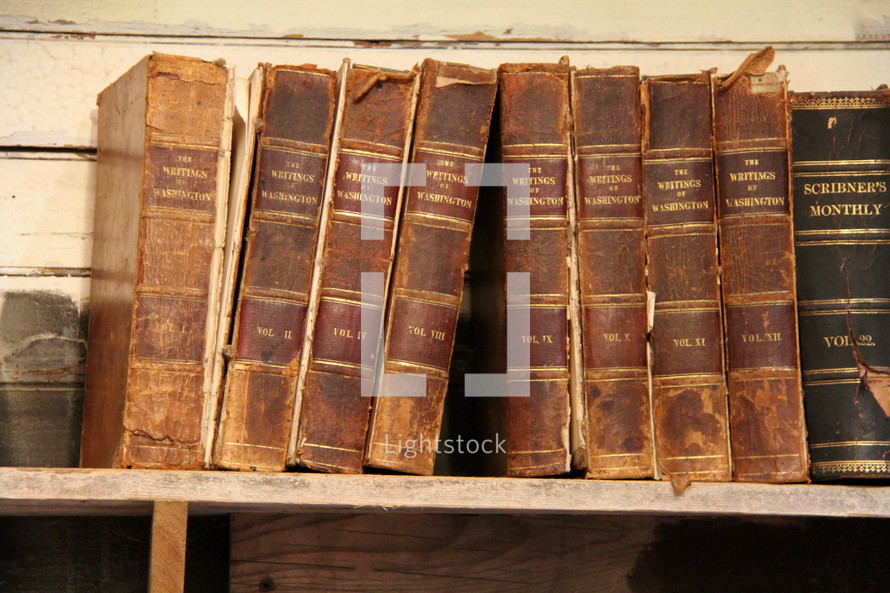 row of antique books on a bookshelf 