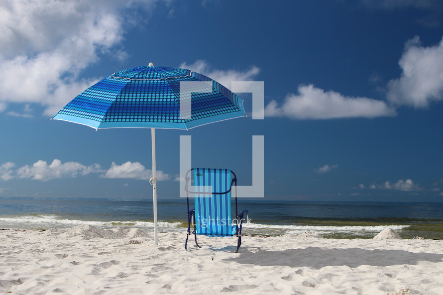 Umbrella and chair on the beach.