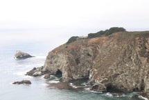sea cave and cliffs along a shore 