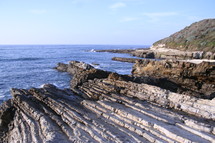 Rocky cliff on ocean beach.
