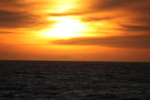 An ocean horizon with a sunset.