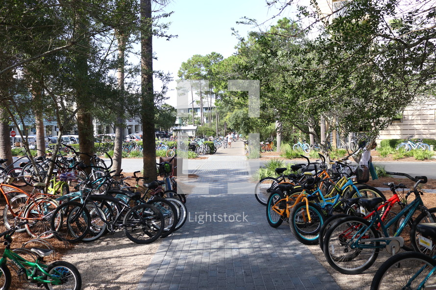 bikes parked everywhere along a sidewalk 