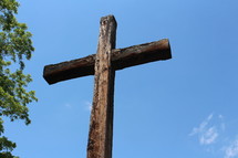 wooden cross against a blue sky 