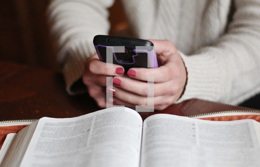 a woman using a Bible app and reading a Bible 