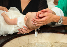 baby baptism in a baptismal font 