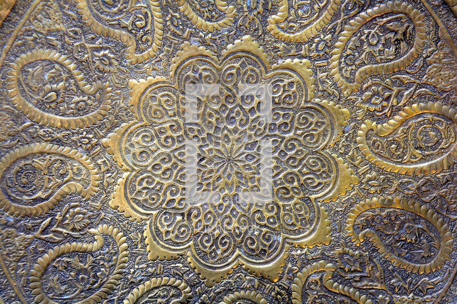 decorative gold and blue pattern in metal 