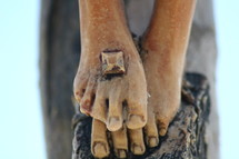 feet of a statue of Jesus with nail