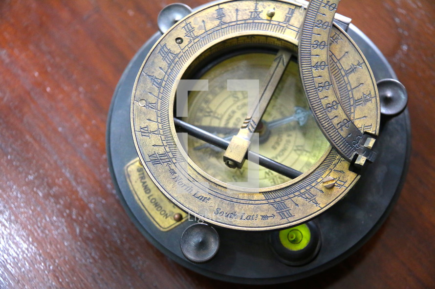 Magnetic compass showing direction, orientation, level and angle of the sun