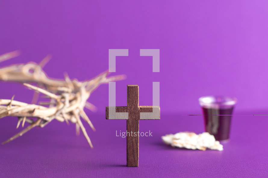 crown of thorns on purple with cross and communion elements 