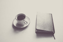 closed Bible and coffee cup 