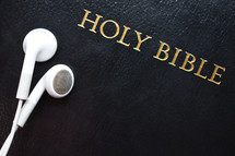 Holy Bible with earbuds 