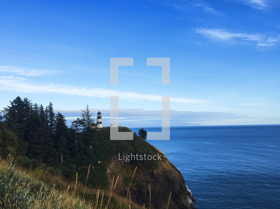 lighthouse on a hill along a coastline 