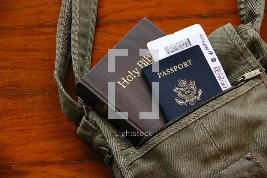 Mission trip, passport, sling bag, air ticket and Bible on a wooden background 