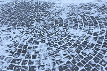 Snow and Ice-covered circular stone path.