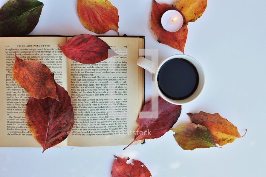 pages of a book, fall leaves, coffee cup 
