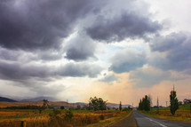 cloudy sky over a rural road 