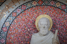 Statue of Jesus and mosaic tile wall 
