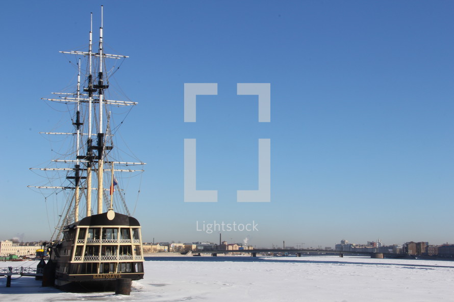 sailboat in a frozen harbor