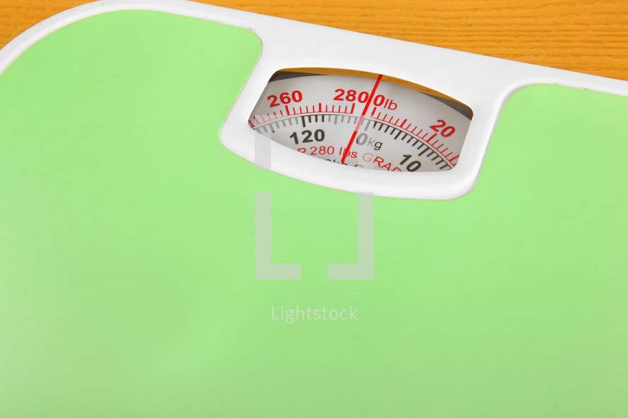 Green bathroom scale isolated on white background