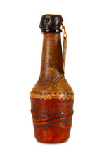Mini bottle covered in leather on white background