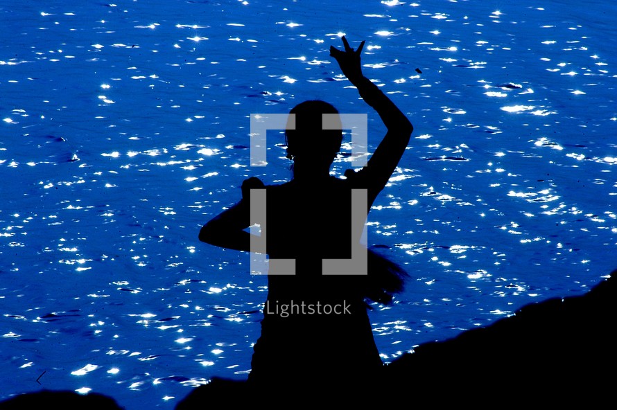 silhouette of a woman with a tambourine 