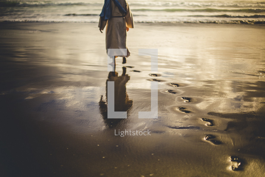 Jesus walking along a shore leaving footprints in the sand 