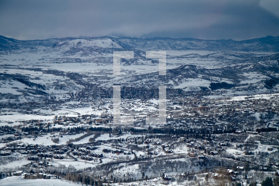aerial view of a snow covered mountain range and valley